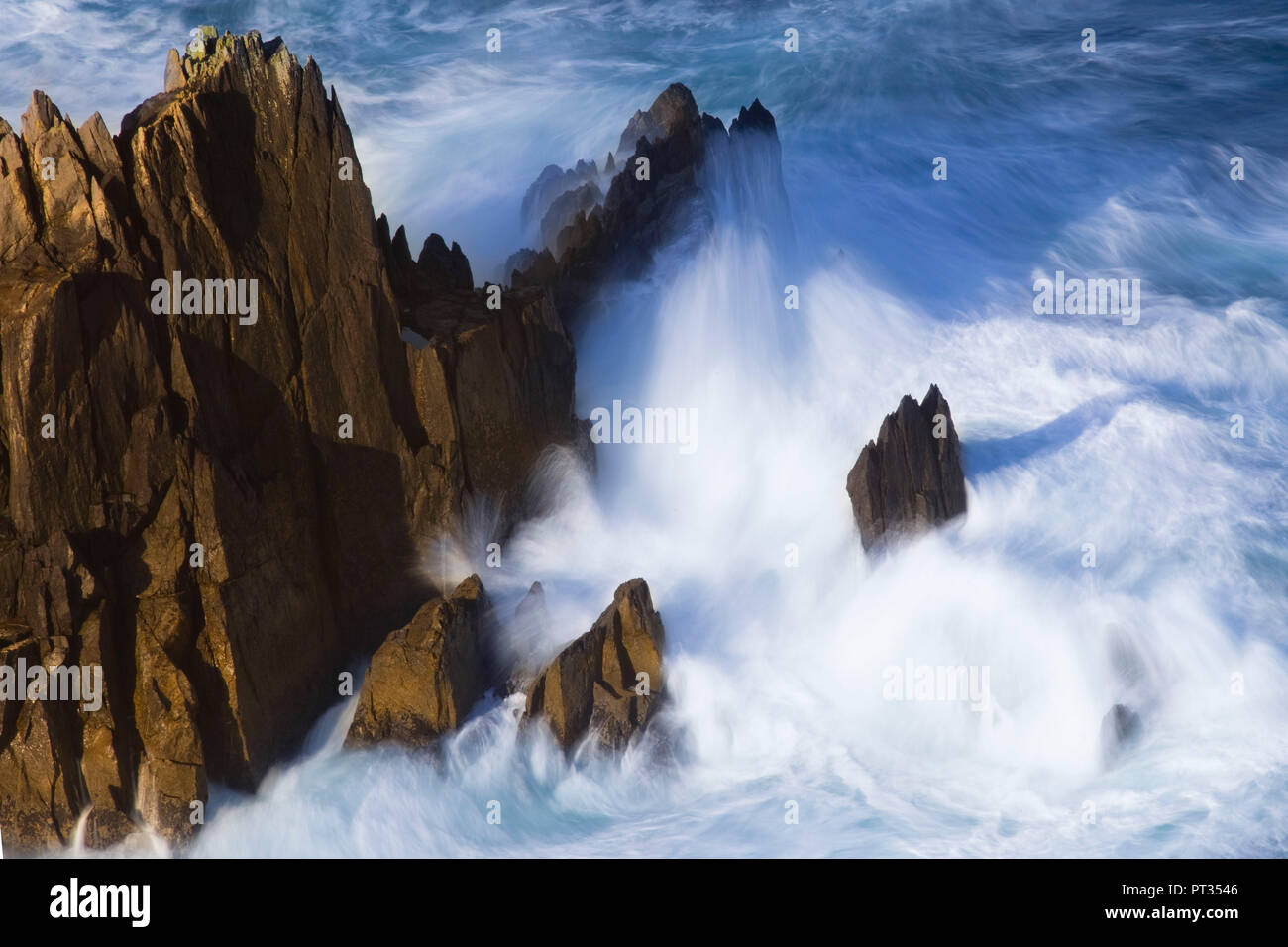 long exposure of ocean surf splashing against rock, Old cabin on Dingle Peninsula, Ireland, Stock Photo