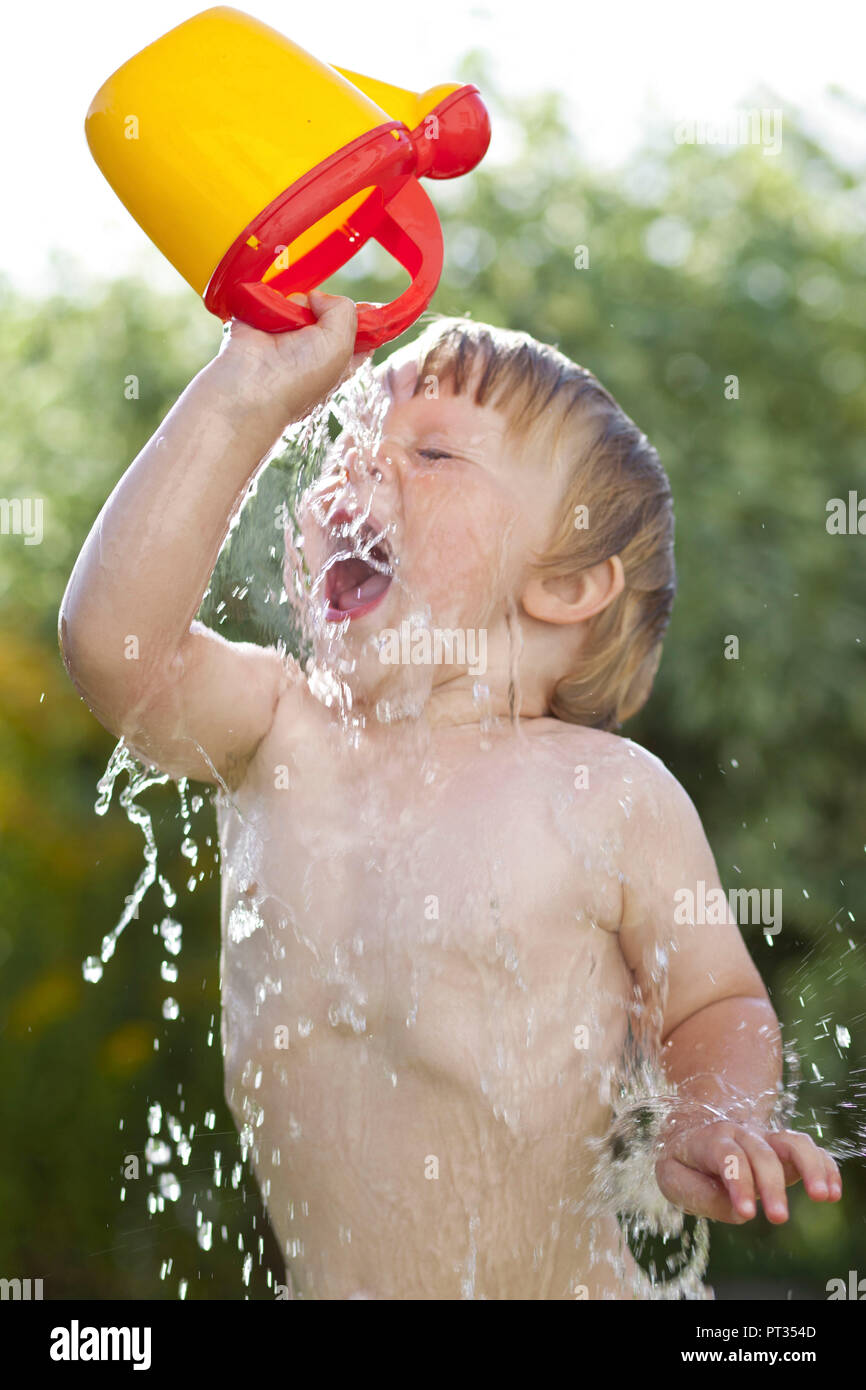 fun kid splashing water Stock Photo
