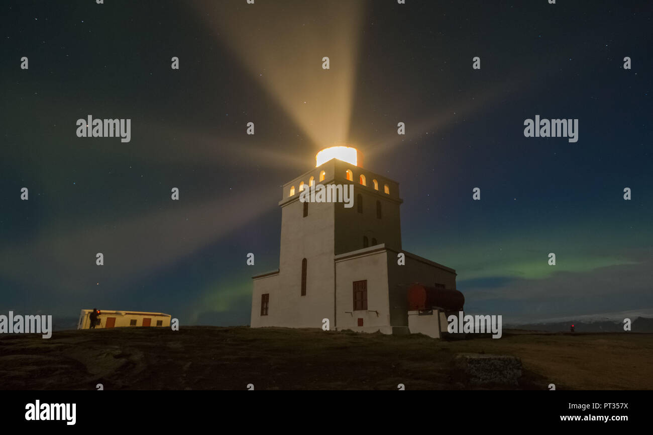 Lighthouse in the night with starry sky and northern lights Stock Photo