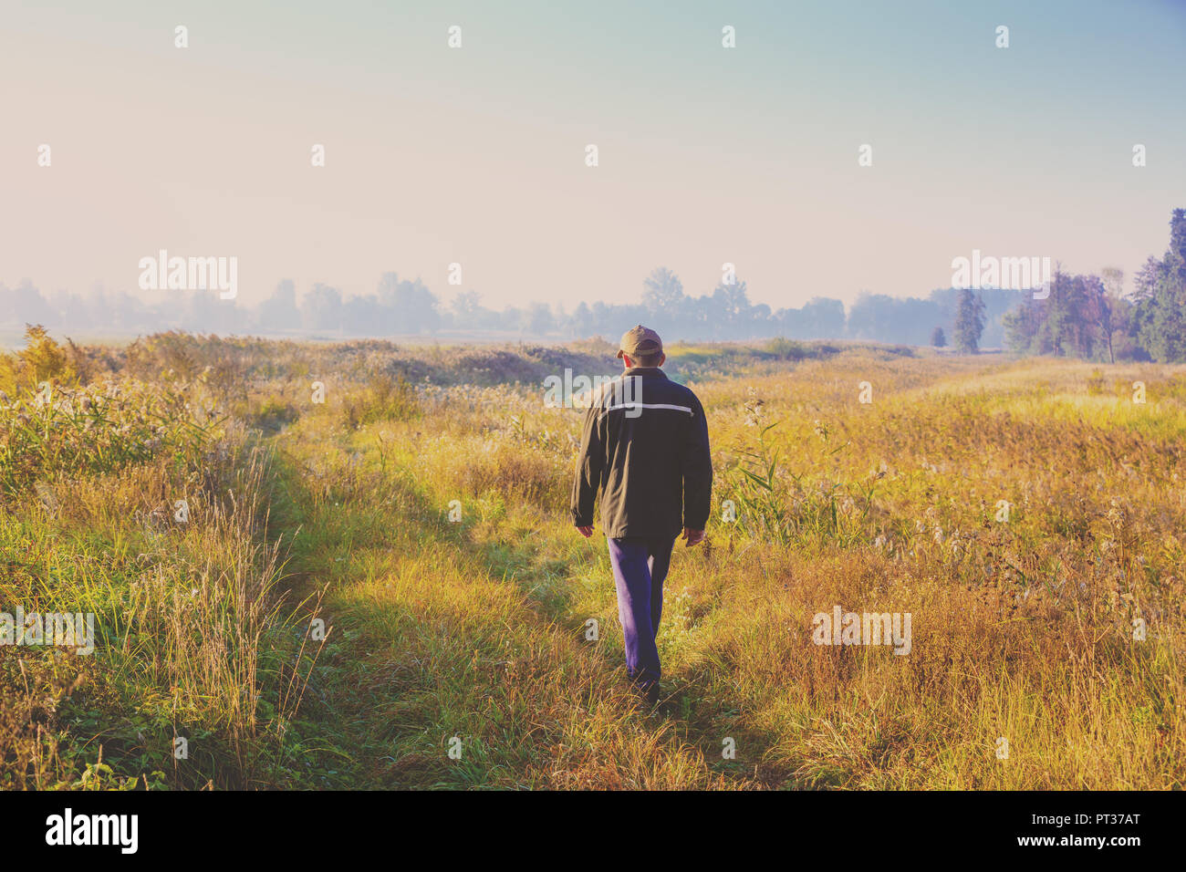 Young man walking through green hi-res stock photography and images - Alamy