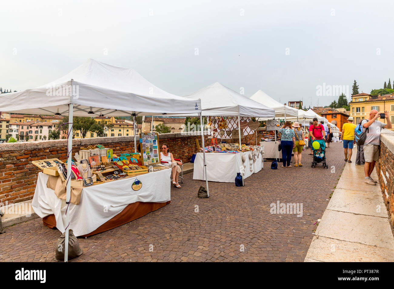 Art market on the Roman bridge Ponta Pietra, river Adige, Verona, Veneto, Italy, Europe Stock Photo