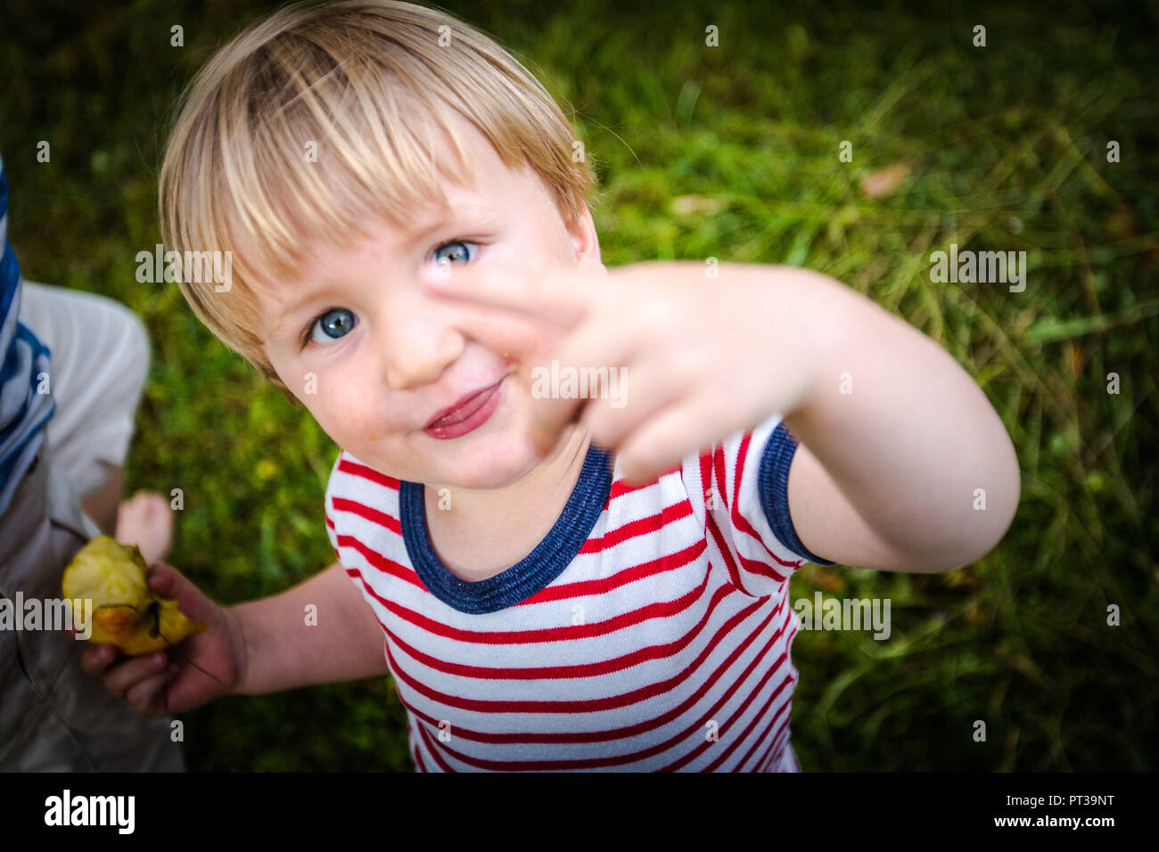 Toddler, two-year-old with red and white striped tee, cheeky, facing camera Stock Photo