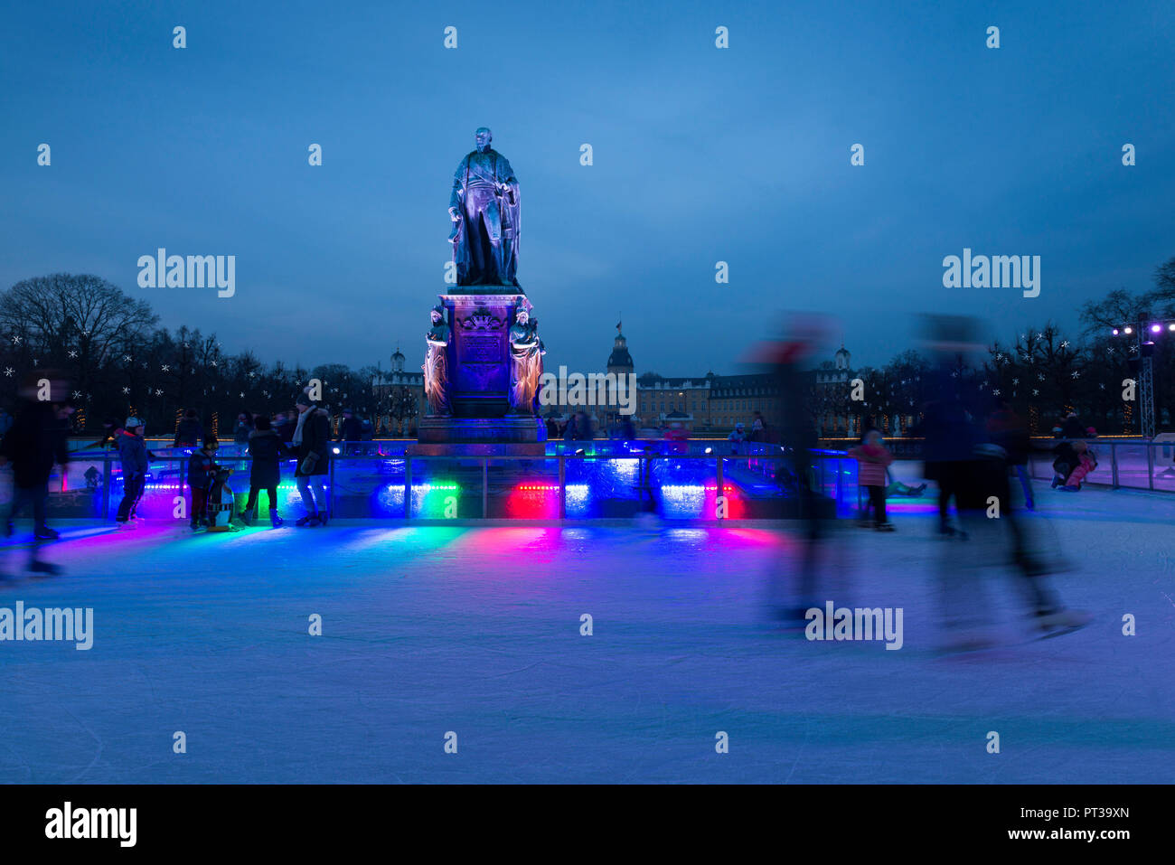 Germany, Baden-Württemberg, Karlsruhe, 'Eiszeit' ice-rink on Schlossplatz (Palace Square) with the monument of Grand Duke Karl Friedrich Stock Photo