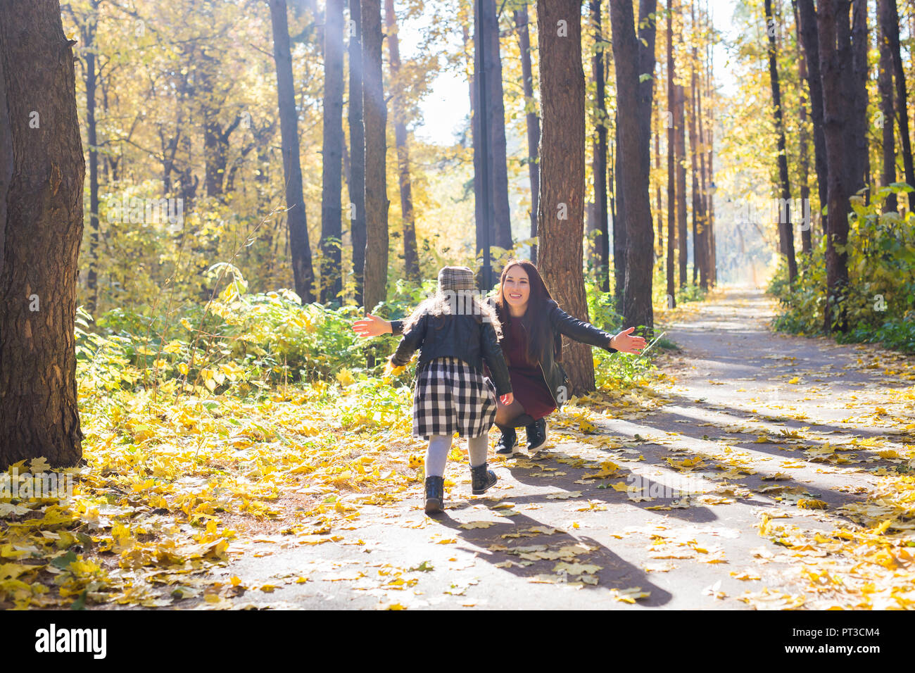 Mother and daughter have fun in autumn park Stock Photo - Alamy