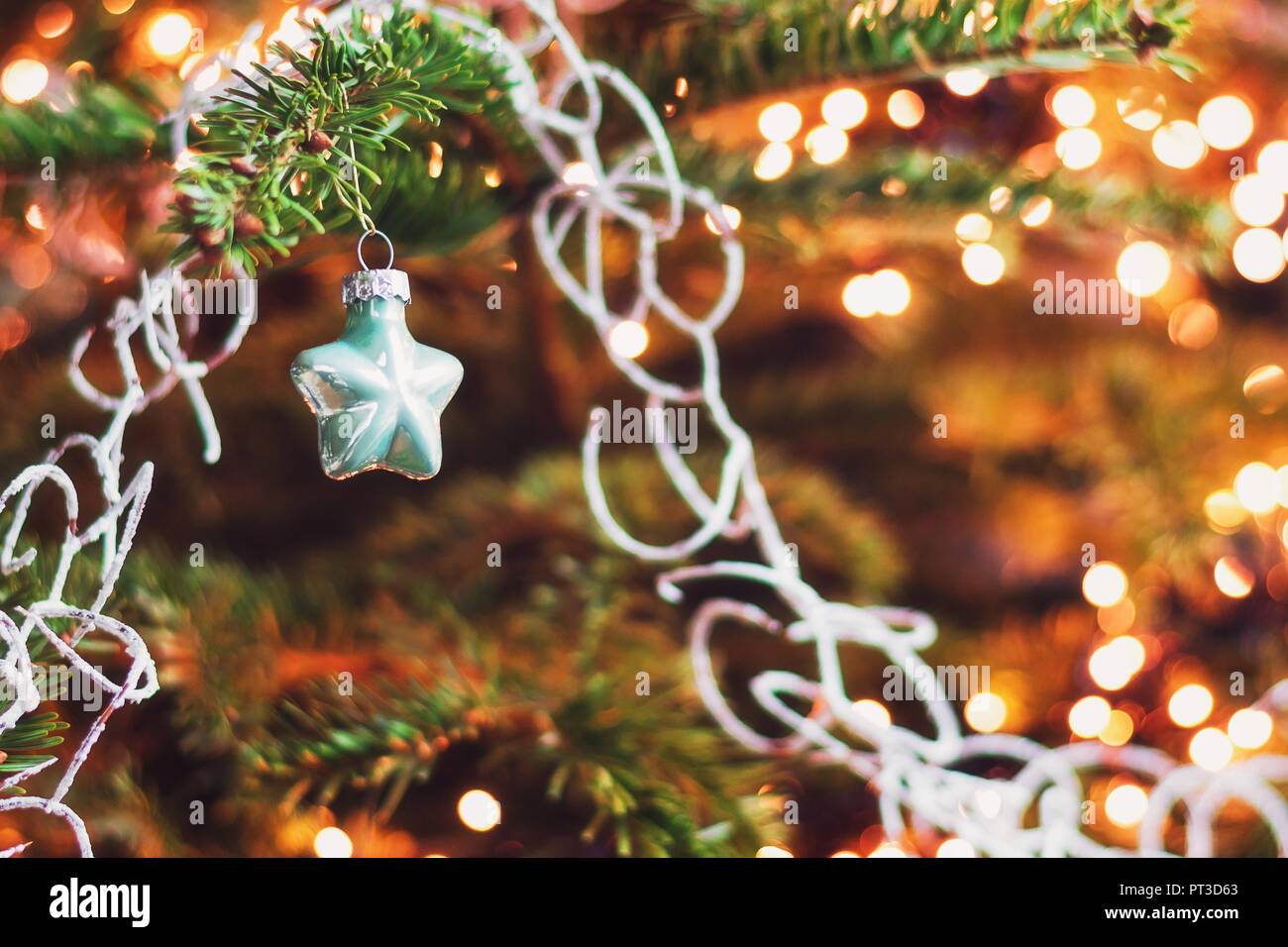 Christmas greeting in  a Christmas branch decorated with a little star. Stock Photo