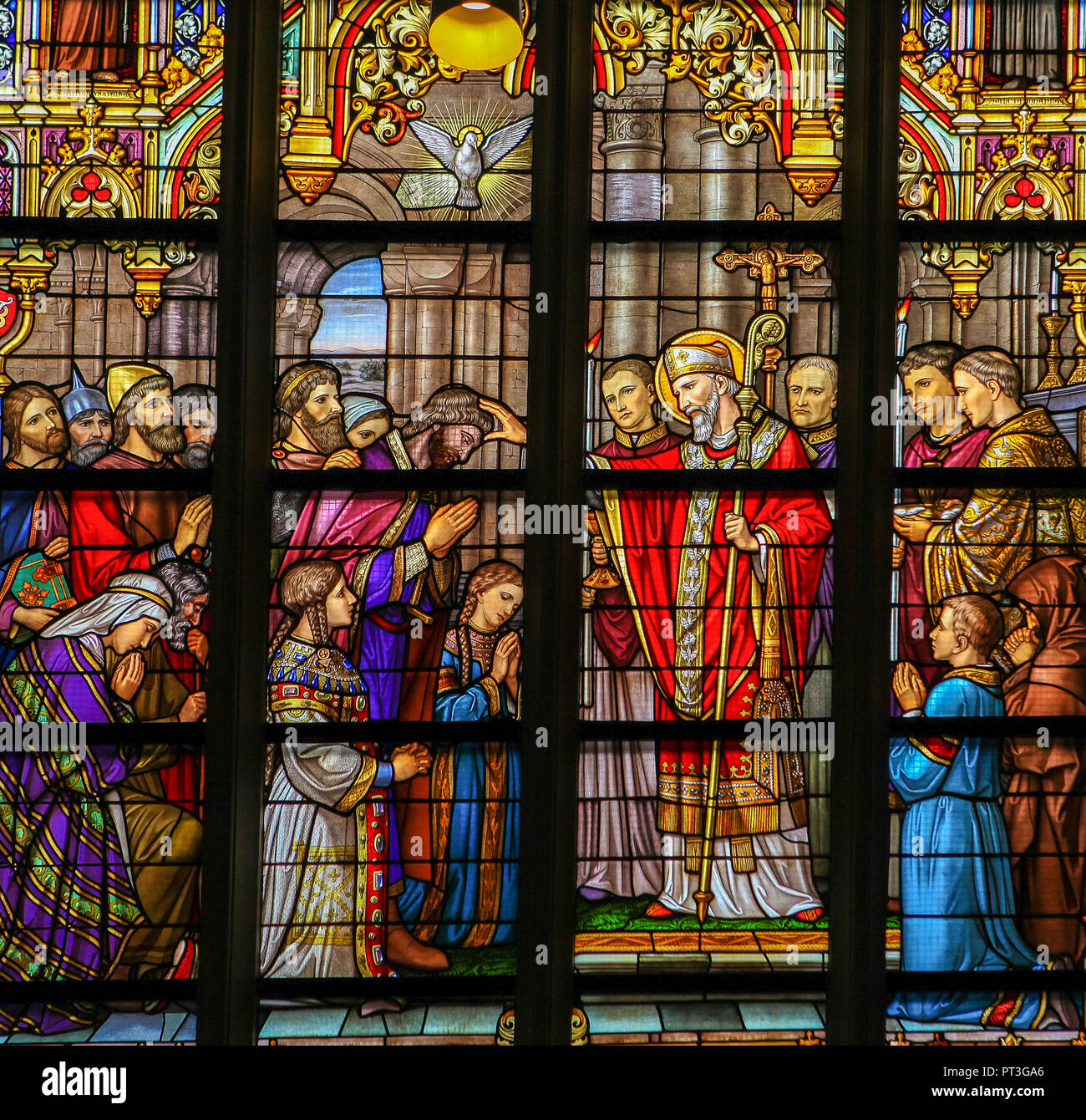 Stained Glass in Den Bosch Cathedral depicting Saint Lambertus anointing the Taxandrians during the Confirmation, the rite of initiation in the Cathol Stock Photo