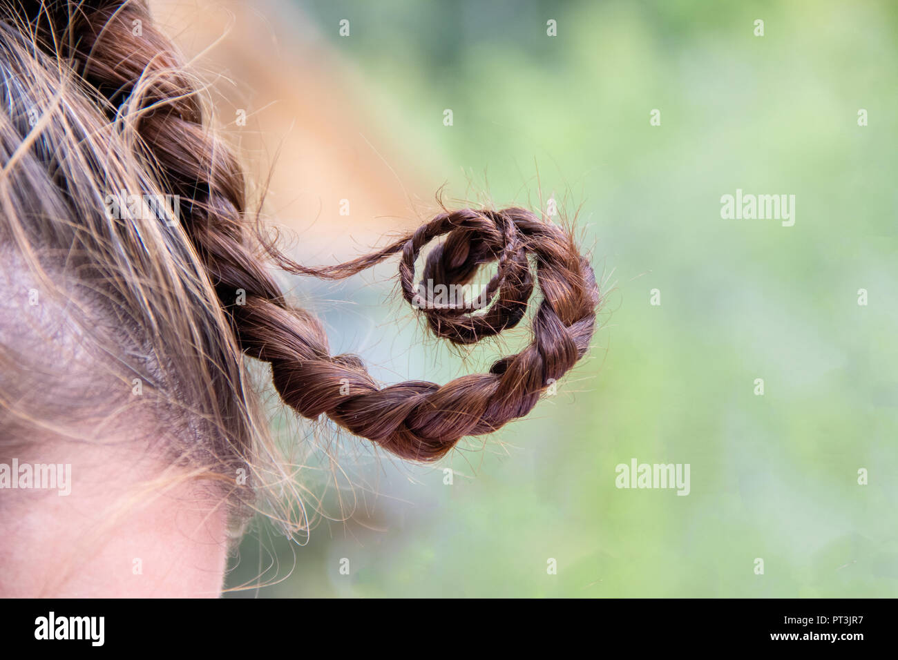 Funny pigtail hair twists on girl head on blurred background Stock Photo