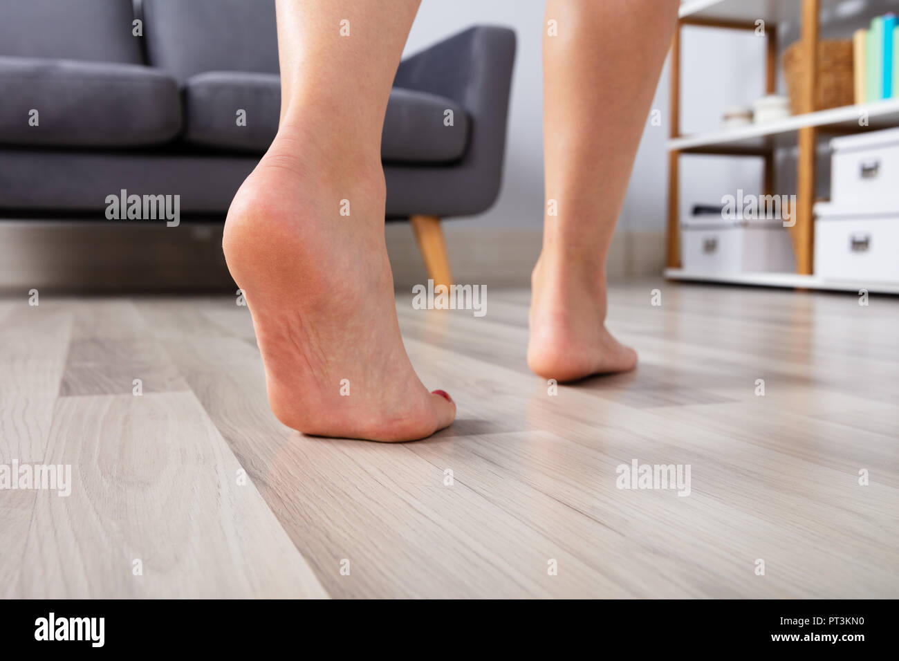 Close Up Of A Woman S Foot Walking On Heated Hardwood Floor Stock