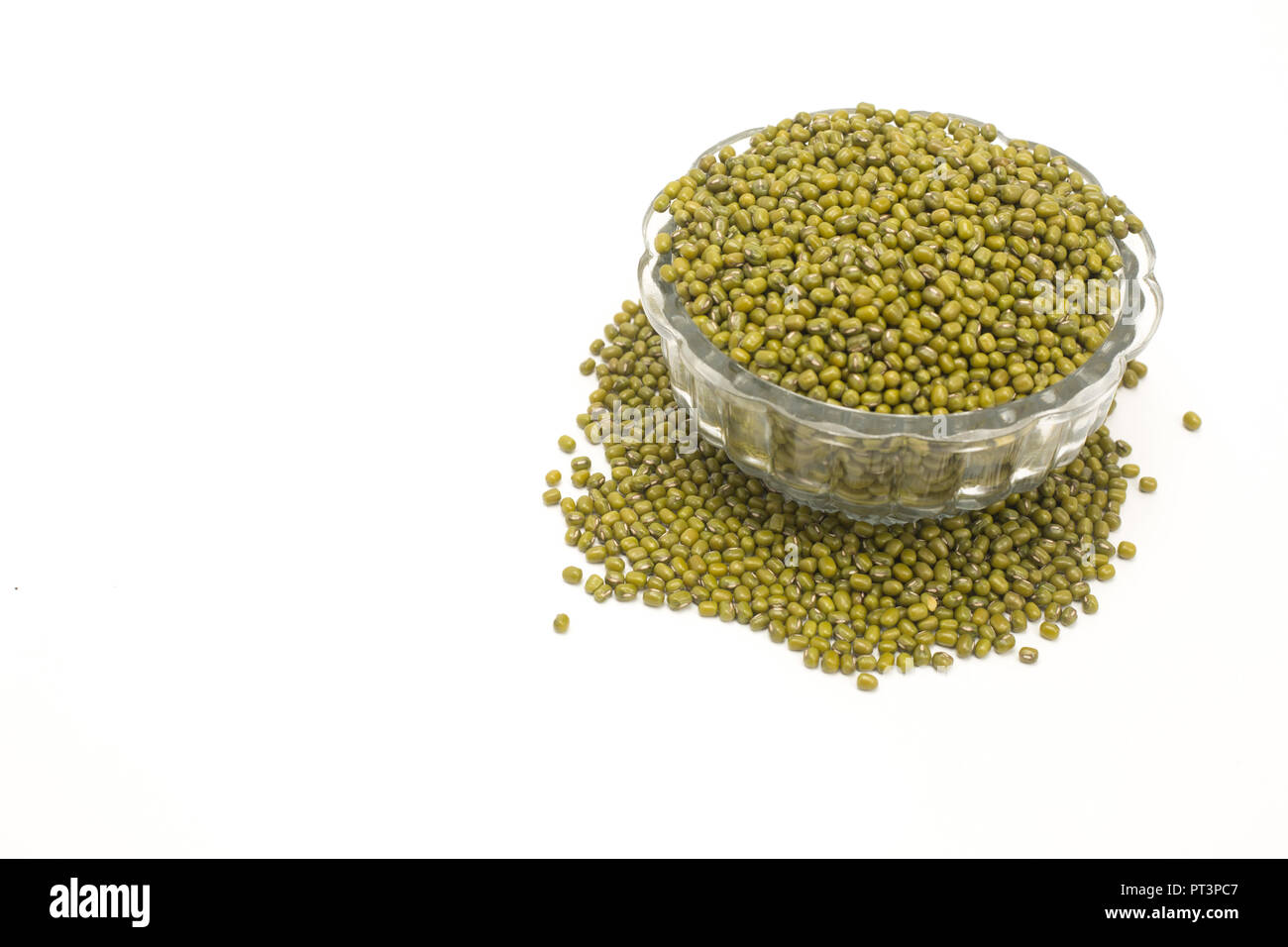 Green mung dal in clear glass bowl isolated on white background. Stock Photo
