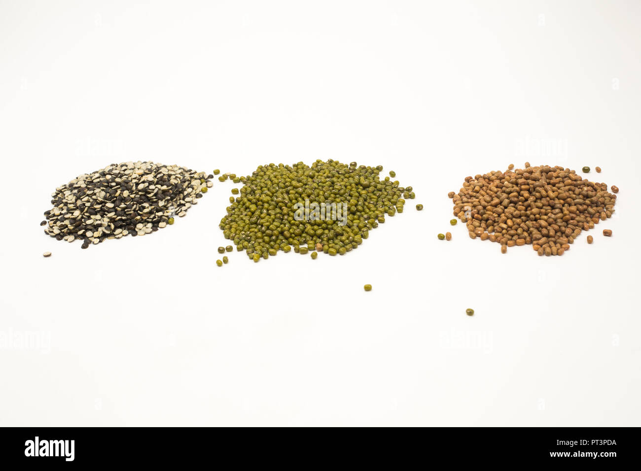 Pile of pulses split black lentil, mung beans, pigeon pea. Isolated on white background. Stock Photo