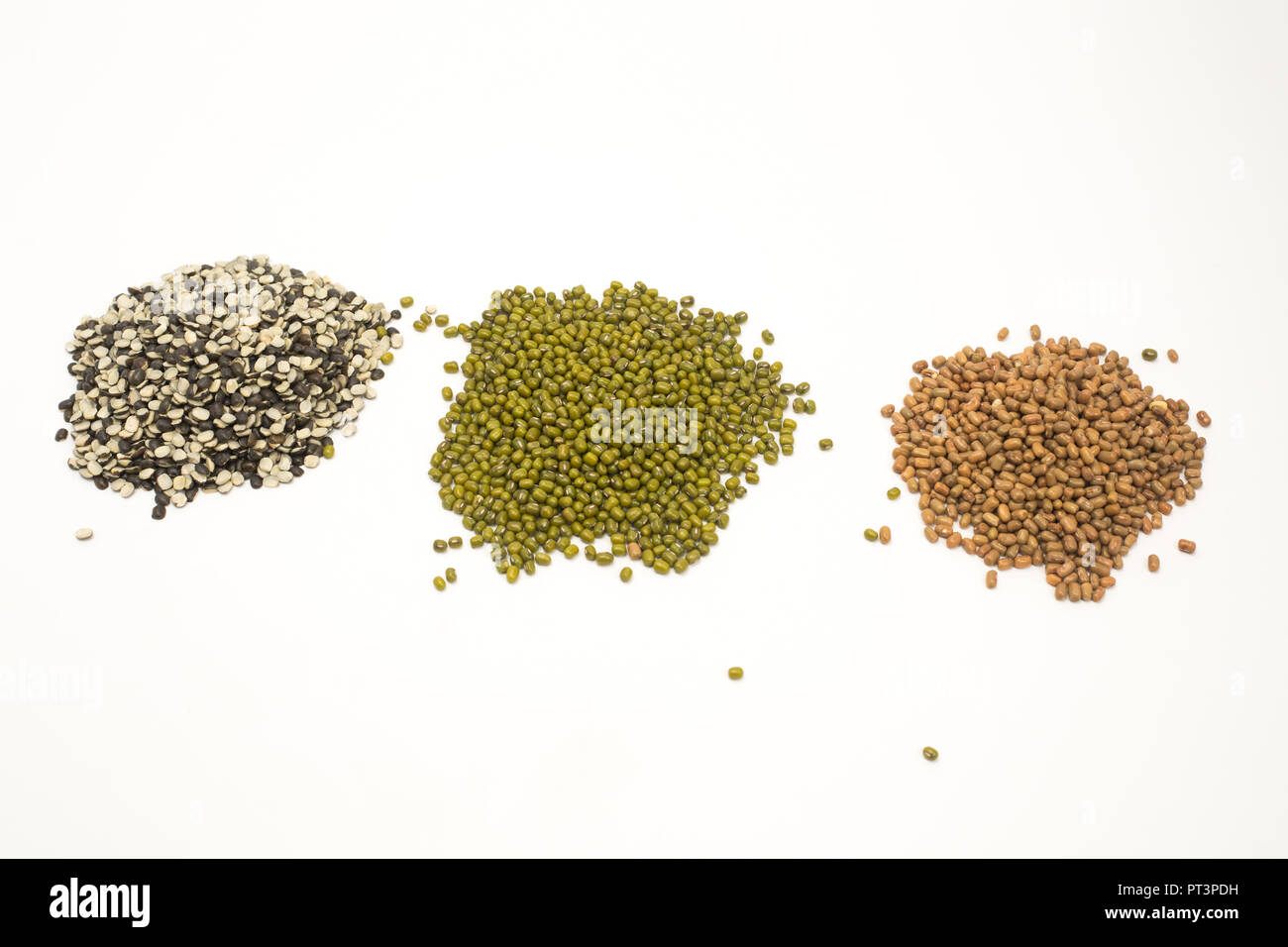 Collection of various seeds split black lentil, green mung beans, pigeon pea. Isolated on white background. Stock Photo