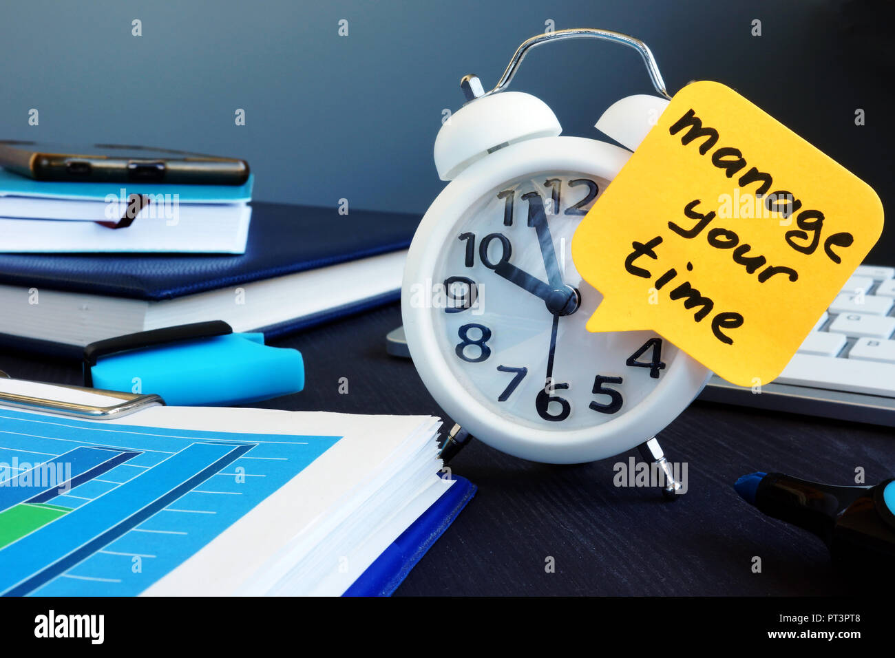 Manage your time. Alarm clock and memo stick. Stock Photo