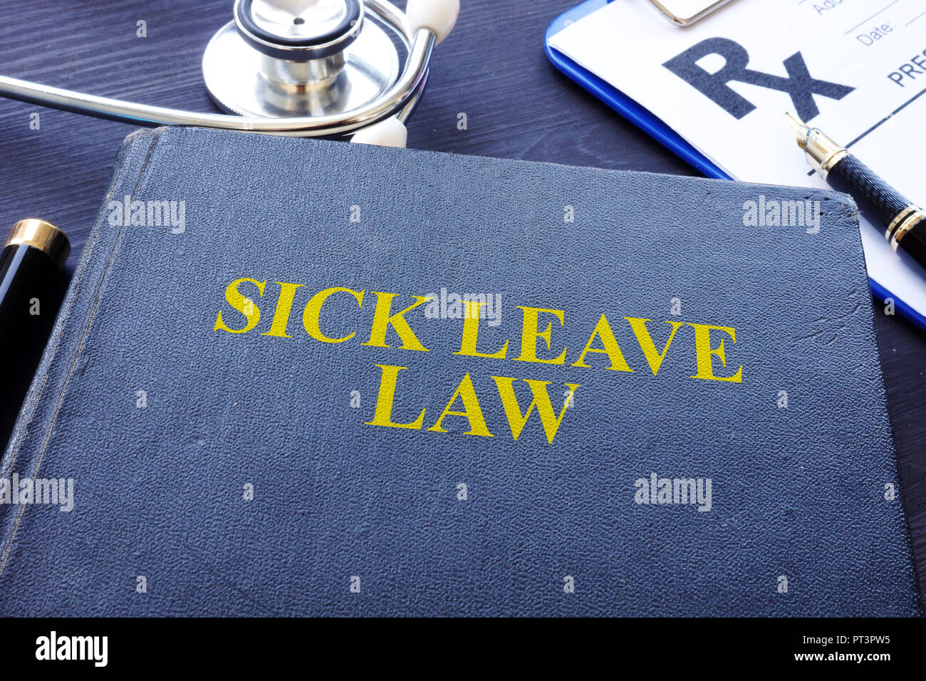 Sick Leave Law book and the stethoscope. Stock Photo