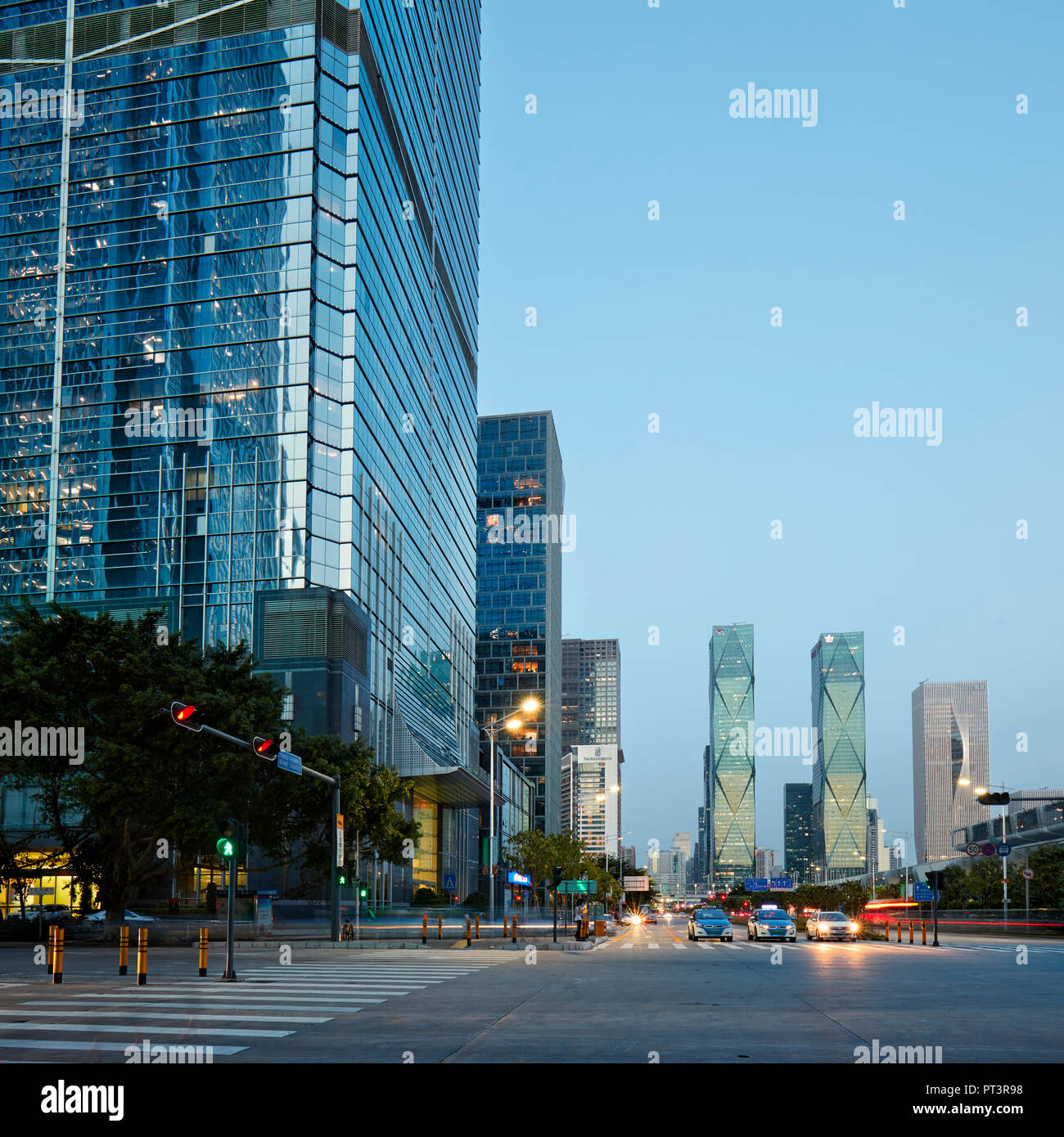 High-rise buildings in Futian Central Business District (CBD) illuminated at dusk. Shenzhen, Guangdong Province, China. Stock Photo