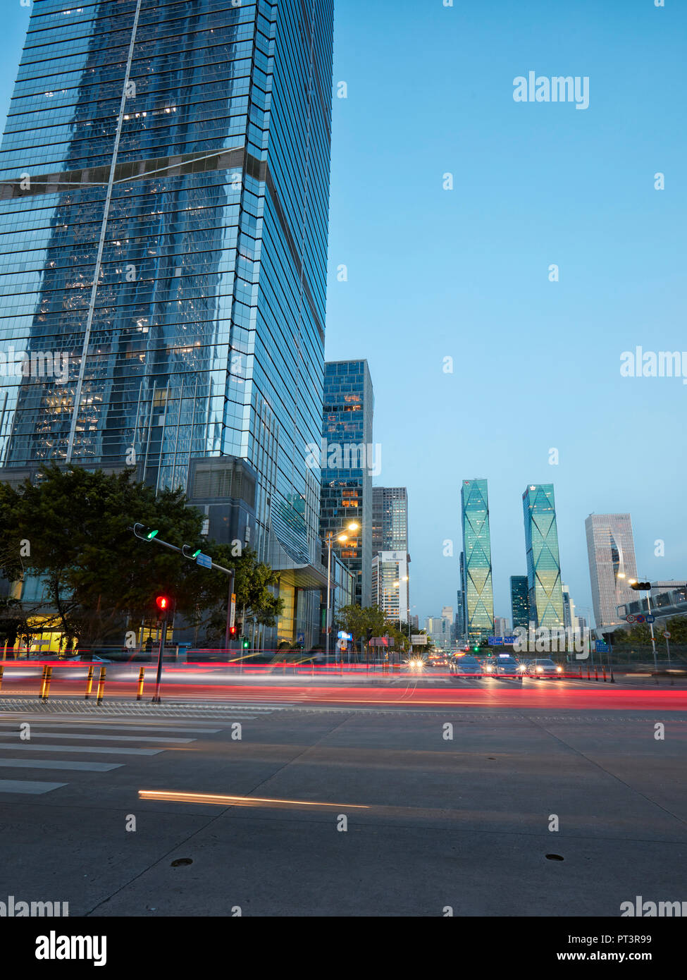 High-rise buildings in Futian Central Business District (CBD) illuminated at dusk. Shenzhen, Guangdong Province, China. Stock Photo