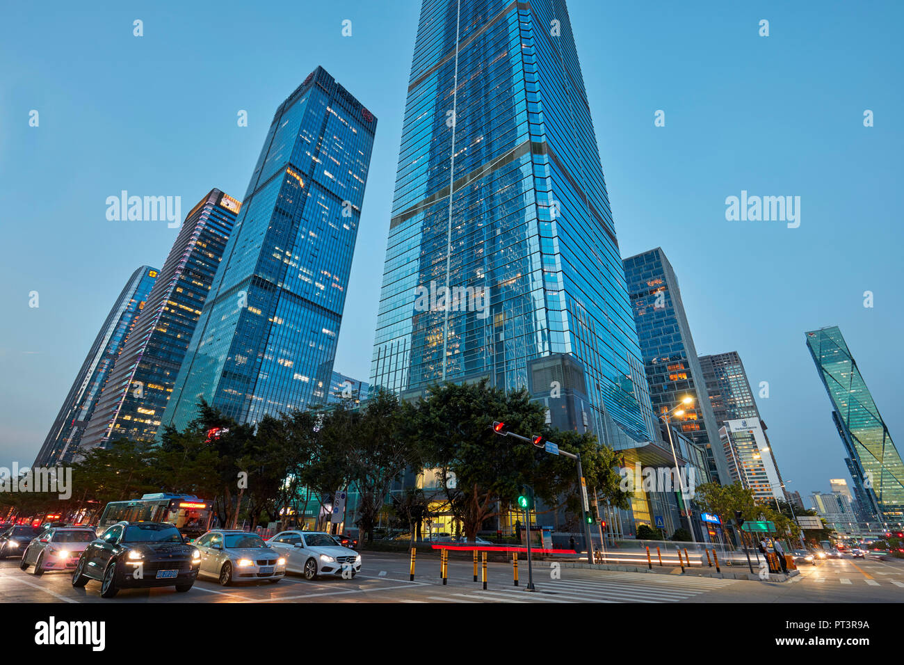 High-rise buildings in Futian Central Business District (CBD) illuminated at dusk. Shenzhen city, Guangdong Province, China. Stock Photo
