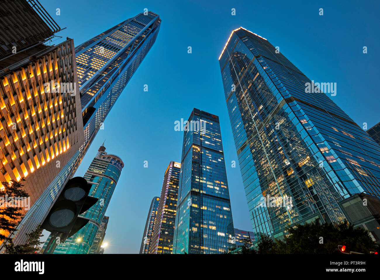 High-rise buildings in Futian Central Business District (CBD) illuminated at dusk. Shenzhen, Guangdong Province, China. Stock Photo