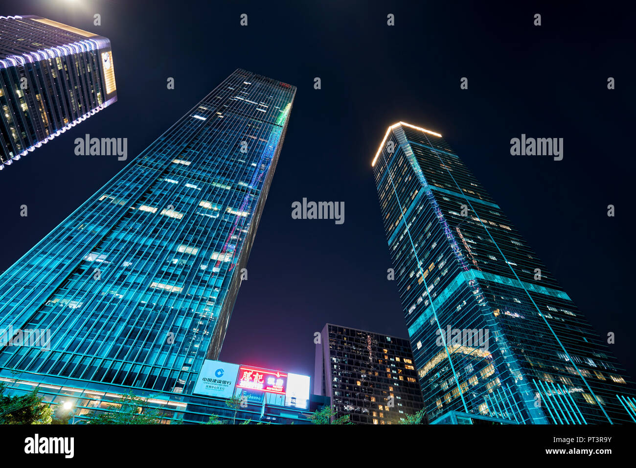 High-rise buildings in Futian Central Business District (CBD) illuminated at dusk. Shenzhen, Guangdong Province, China. Stock Photo
