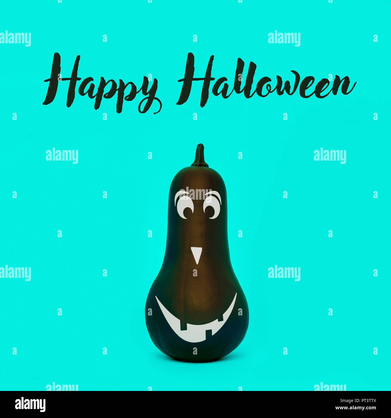 Cute Halloween pumpkin with funny smiling face over pastel blue background. Halloween minimal concept. Stock Photo