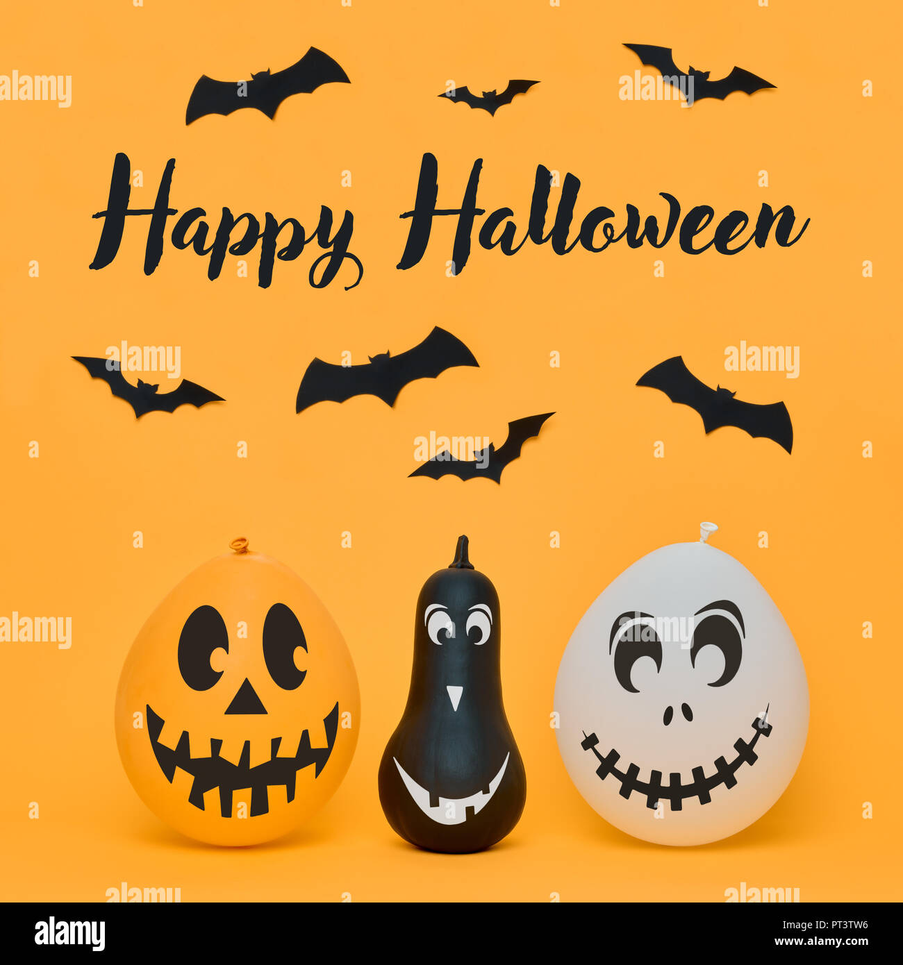 Cute Halloween pumpkins with funny smiling faces and paper bats flying ...