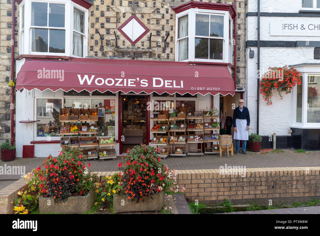 A staff member or business owner standing outside Woozie's Deli