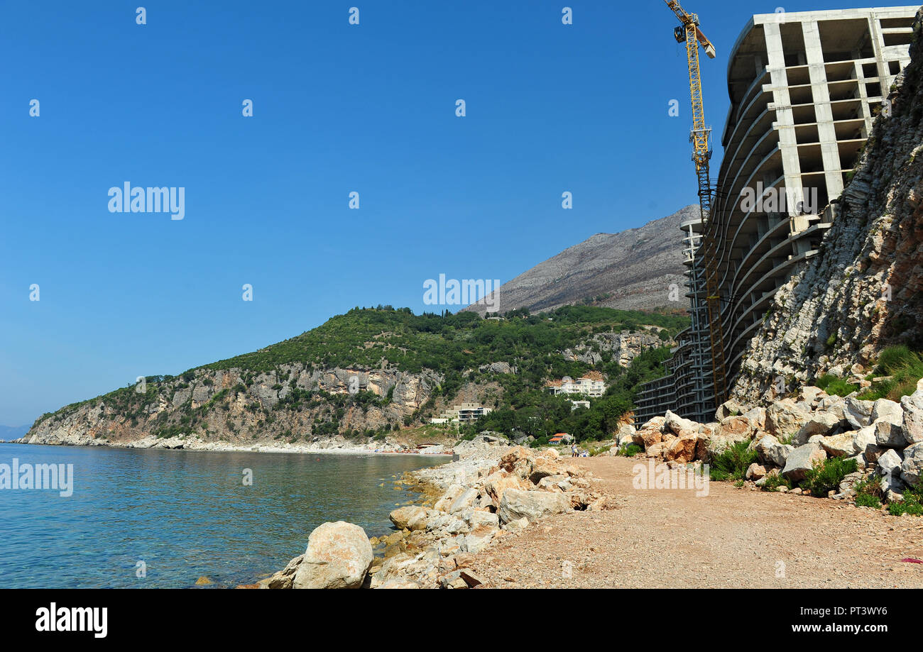 Abandoned and unfinished hotel in Montenegro. Empty abandoned building on beach in Montenegro, Europe.  Horizonatal image with copy space. Stock Photo