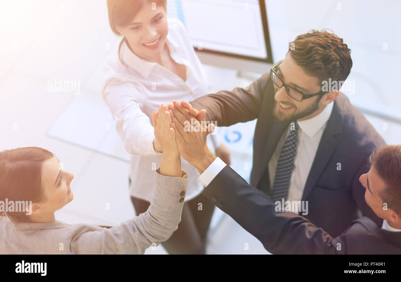 successful business team giving each other a high-five, standing in the ...