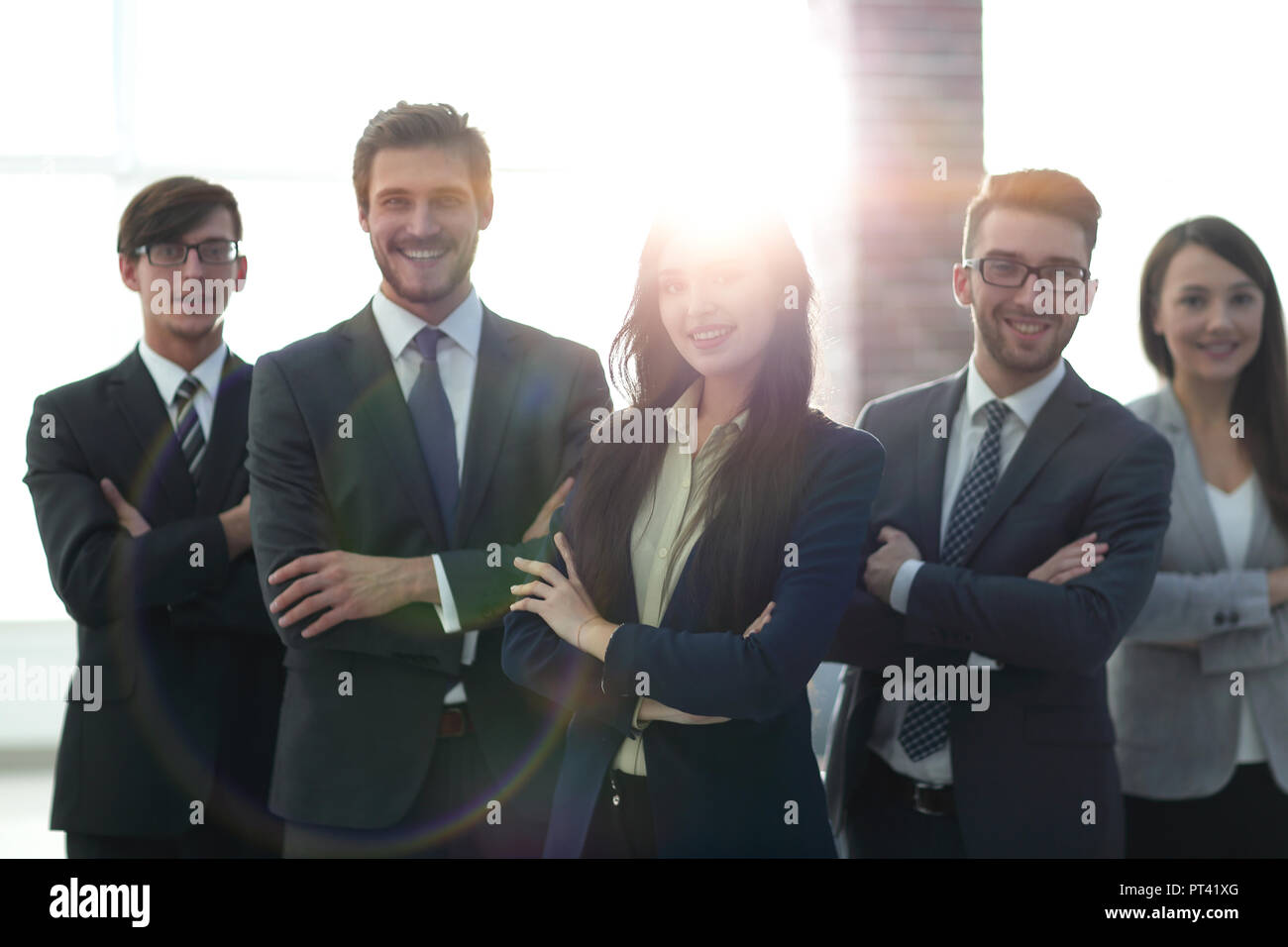 Happy smiling business team standing in a row at office Stock Photo - Alamy