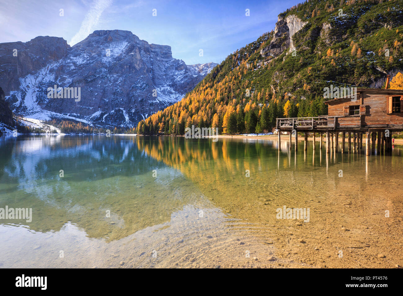 Colorful woods and peaks are reflected in Lake Braies Natural Park of Fanes Sennes Bolzano Trentino Alto Adige Italy Europe Stock Photo