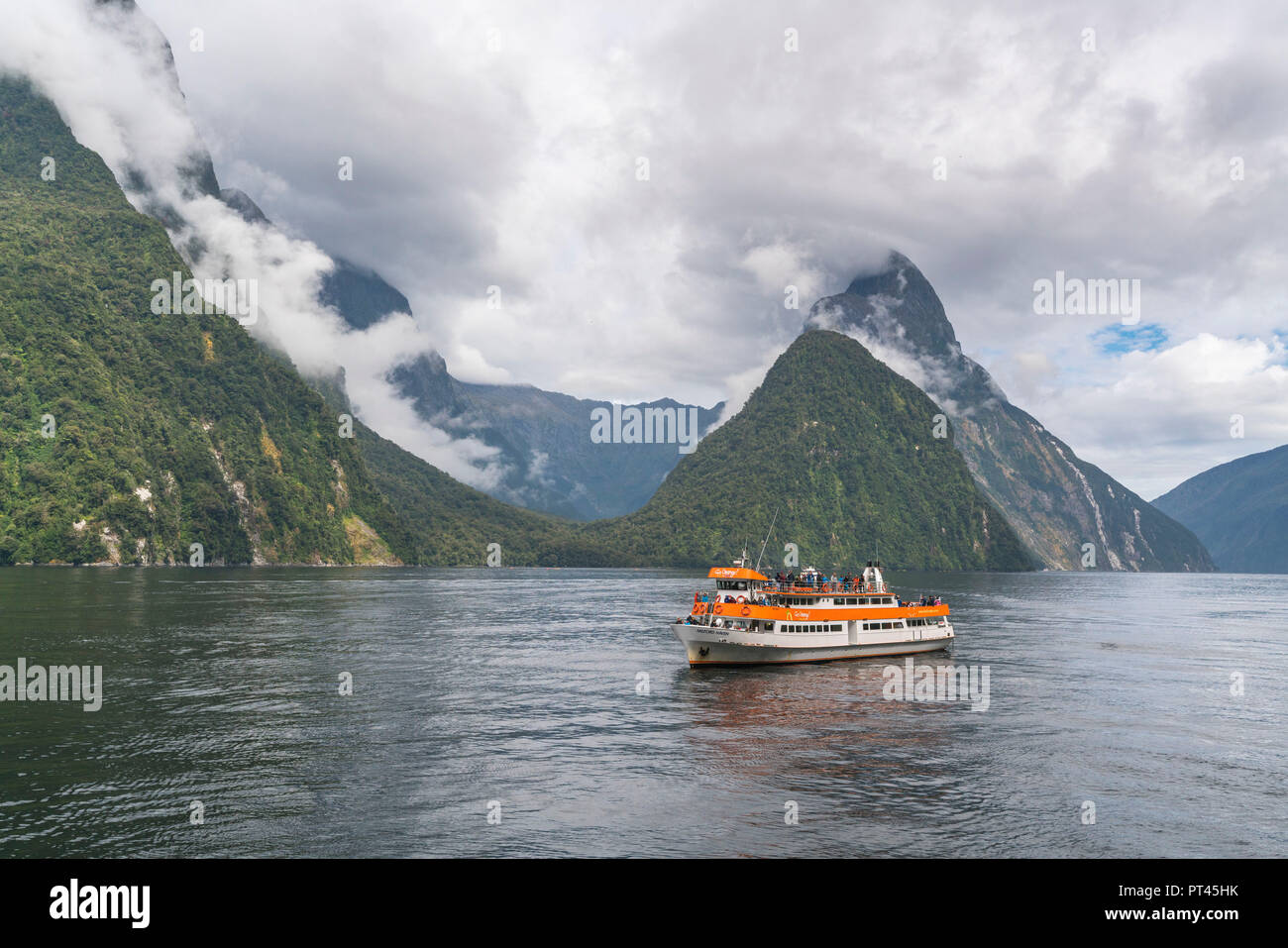 Touristic boat cruising in Milford Sound, Fiordland NP, Southland district, Southland region, South Island, New Zealand, Stock Photo