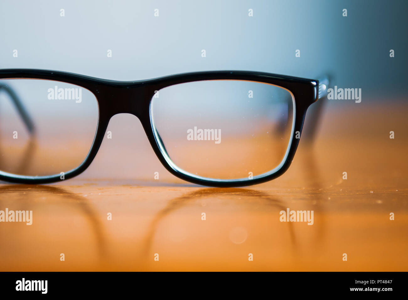 Eyeglasses on wooden table Stock Photo