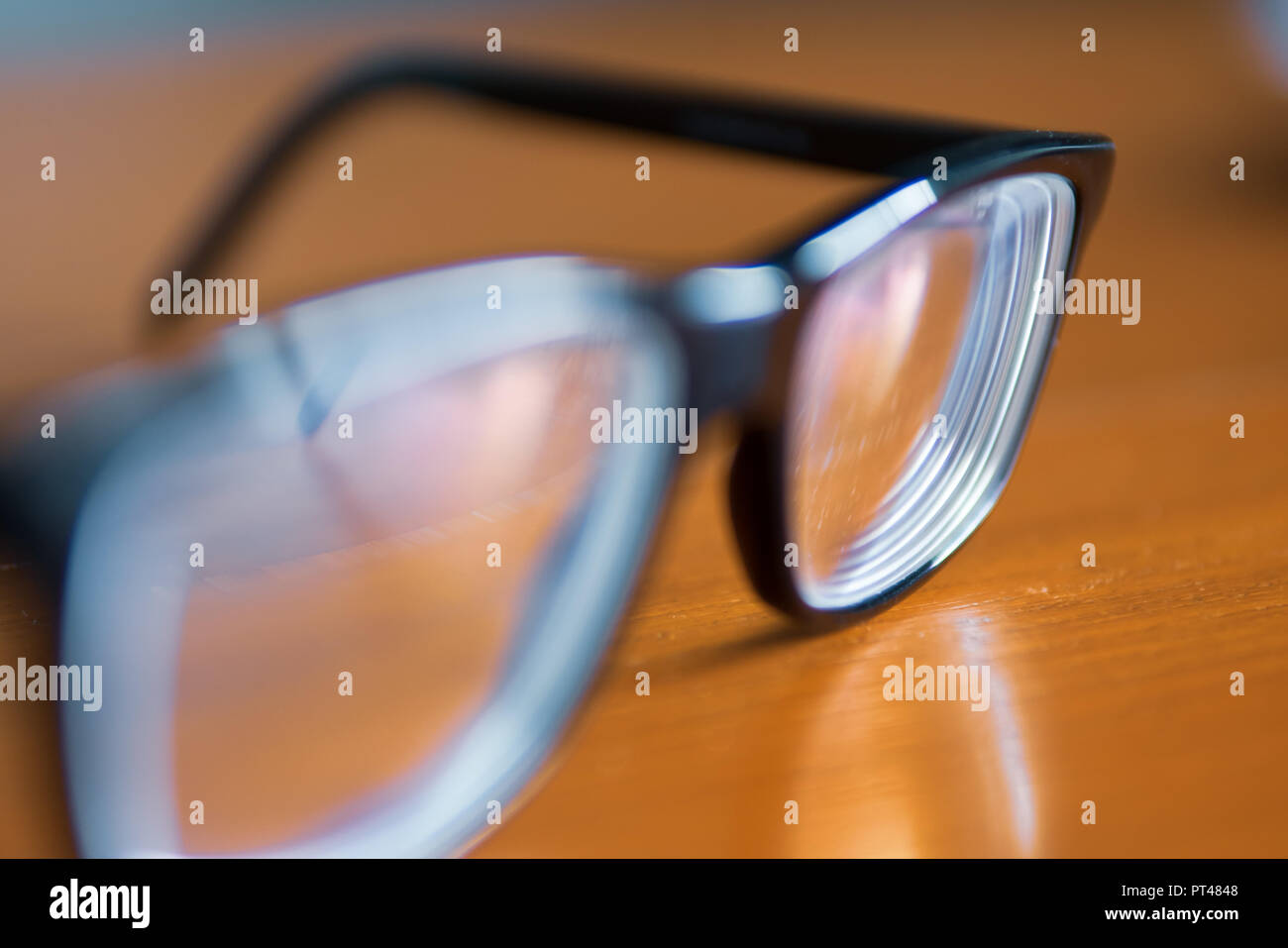 Eyeglasses on wooden table Stock Photo