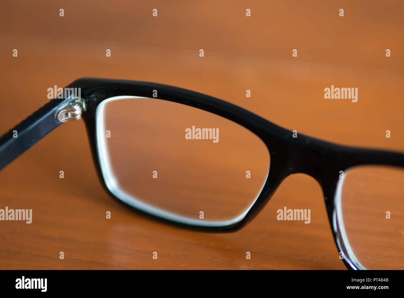 Eyeglasses on wooden table Stock Photo
