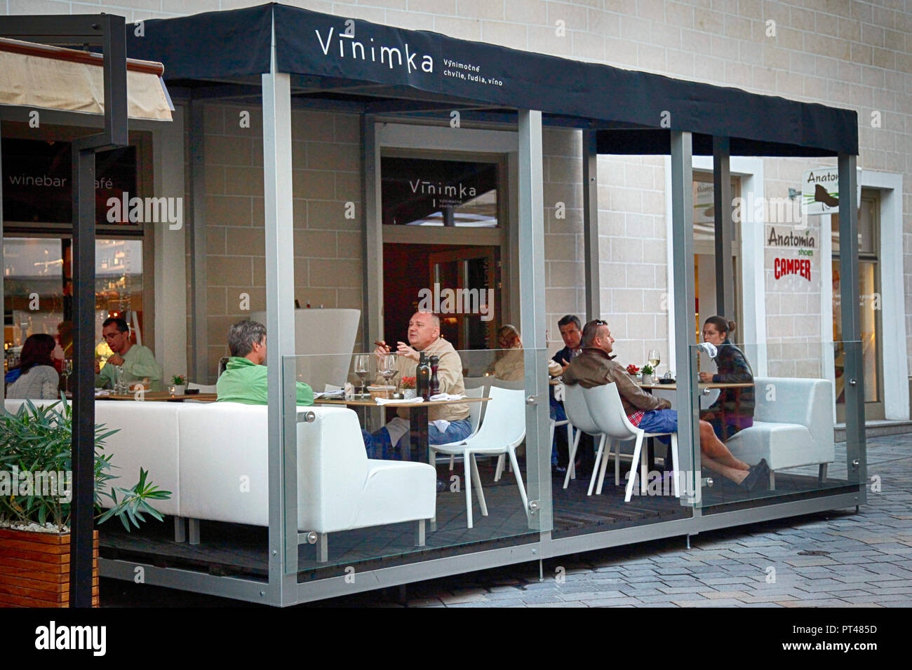 Patrons enjoy outside dining at Vinimka, an upscale and trendy restaurant in the town center of Bratislava, Slovakia Stock Photo