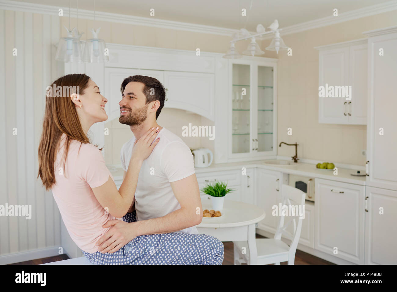 Young couple having fun in the kitchen. Stock Photo