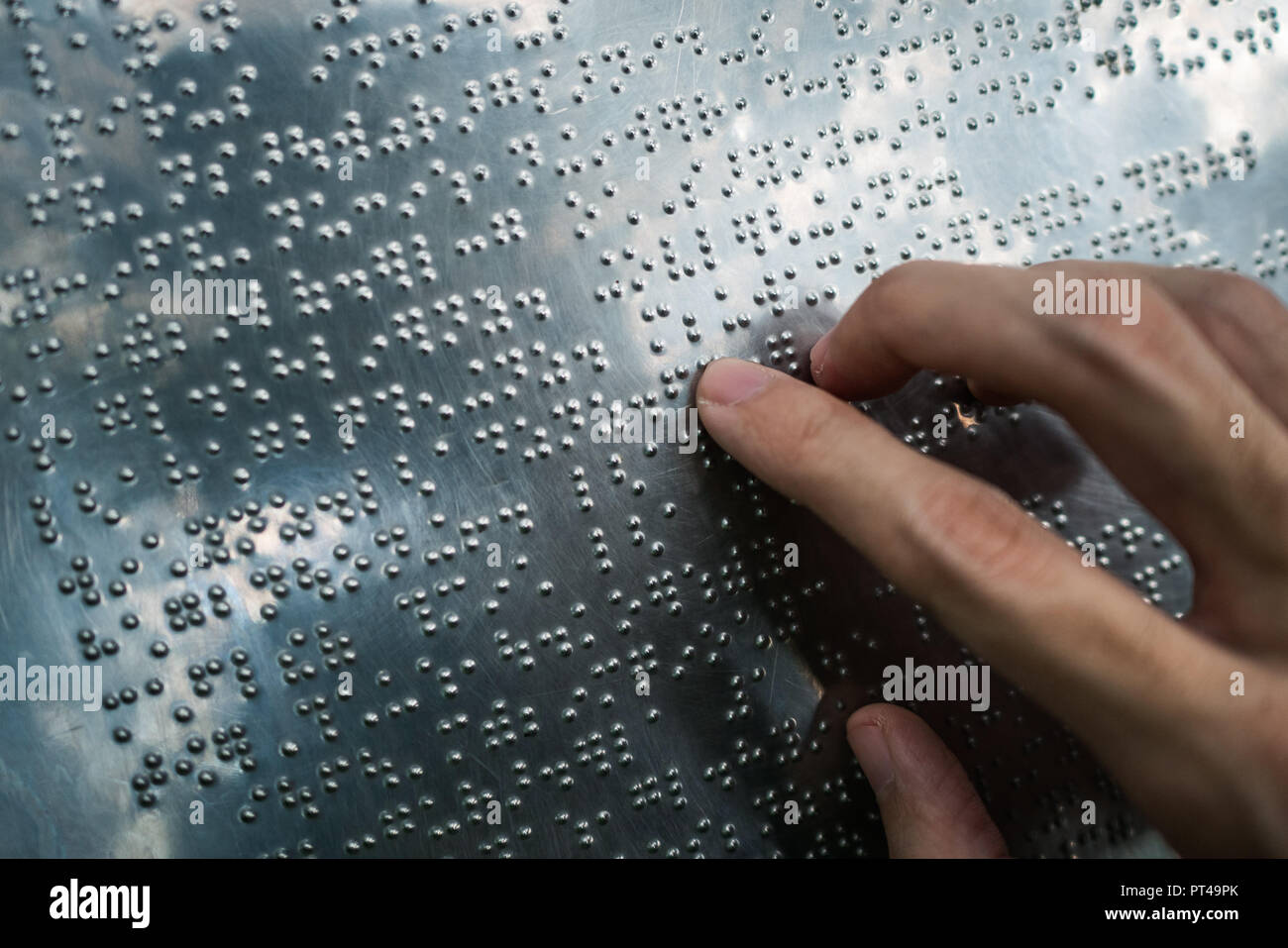 Blind person reading braille text Stock Photo