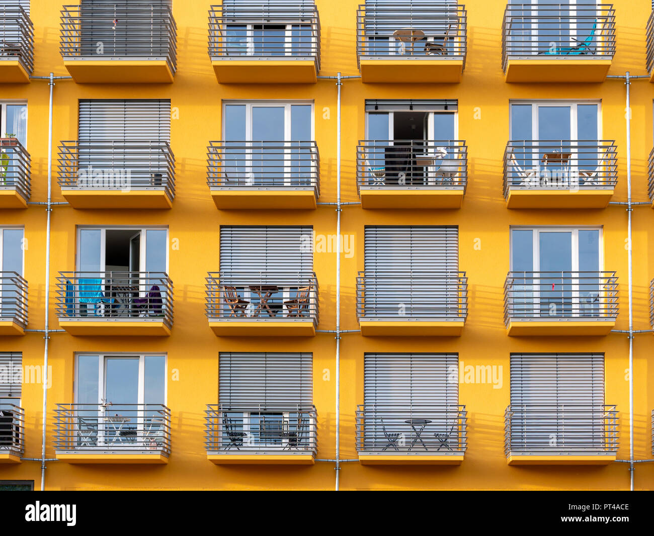 Close up image of yellow high rise building with windows and balconies ...