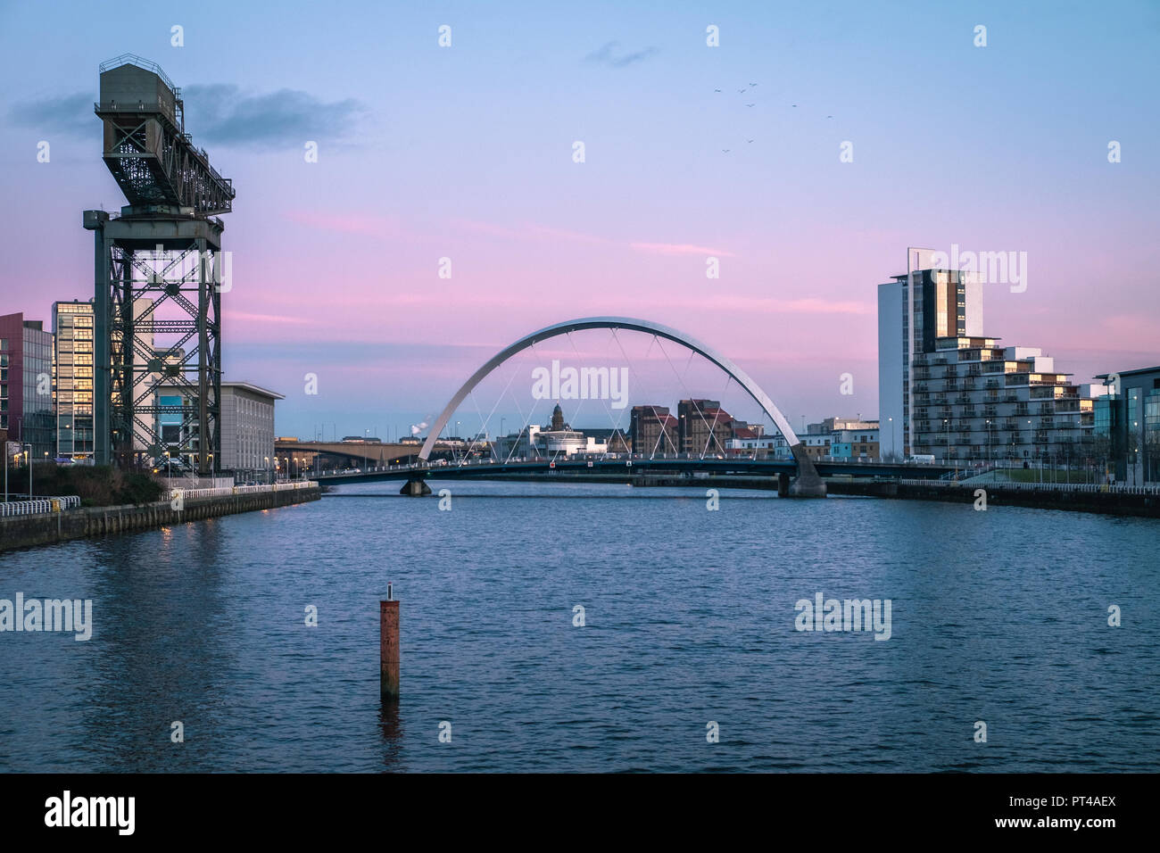 Sunset view of the Clyde Arc or Squinty Bridge and river Clyde, Glasgow, Scotland Stock Photo