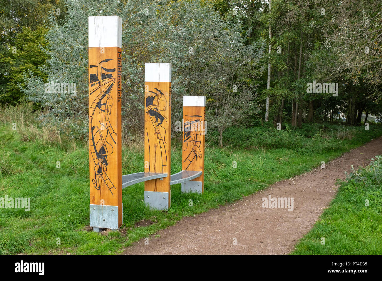 Canal Way Marker and oak benches on the Trent and Mersey Canal in Middlewich Cheshire UK Stock Photo