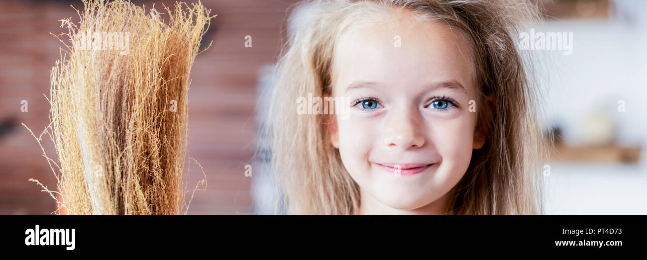 Cute Little Girl With Messy Hair Dressed Up As A Witch Holding A