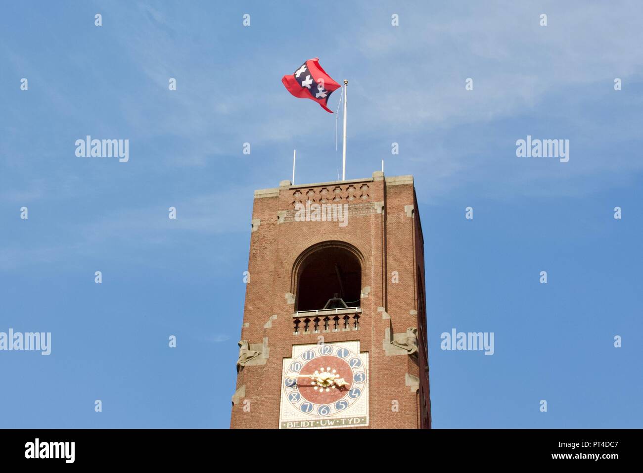 Beurs van Berlage Toren or tower with the Amsterdam flag on top blowing in the wind. Beurs van Berlage is the former stock exchange building. Stock Photo