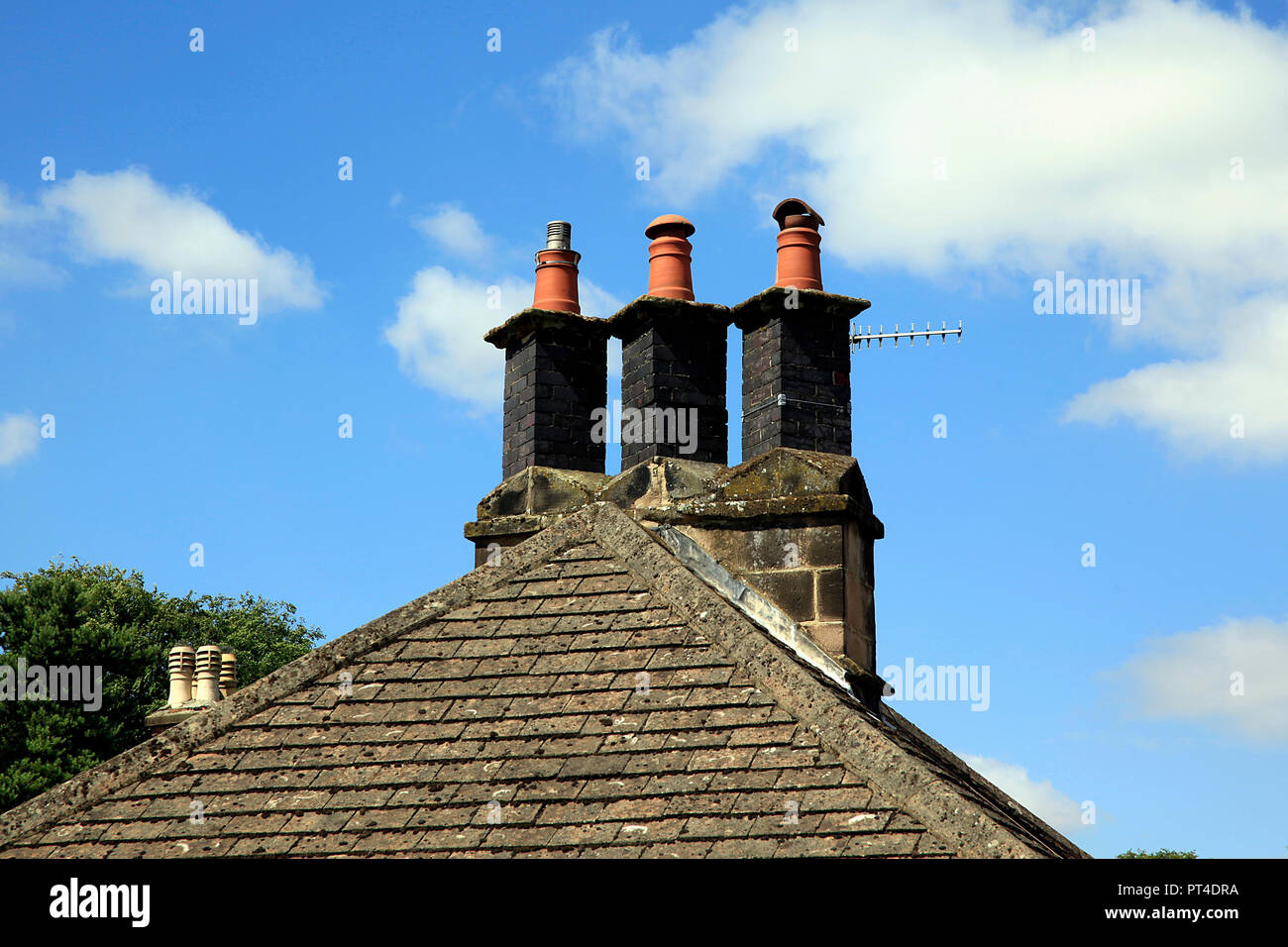 Triple chimney stack on house roof Stock Photo