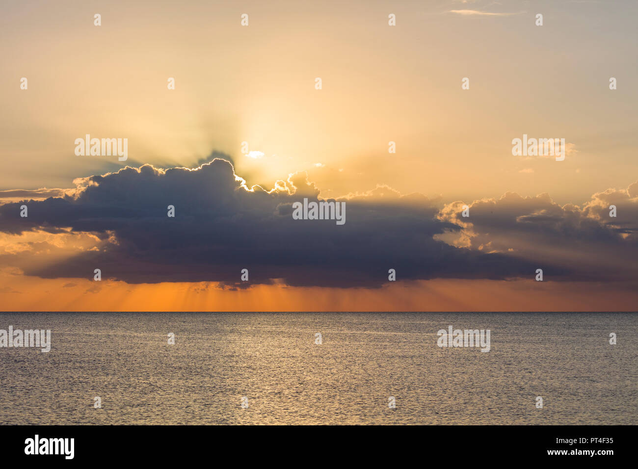 God rays from behind clouds near sunset over the Gulf of Mexico in southwestern Florida United States Stock Photo