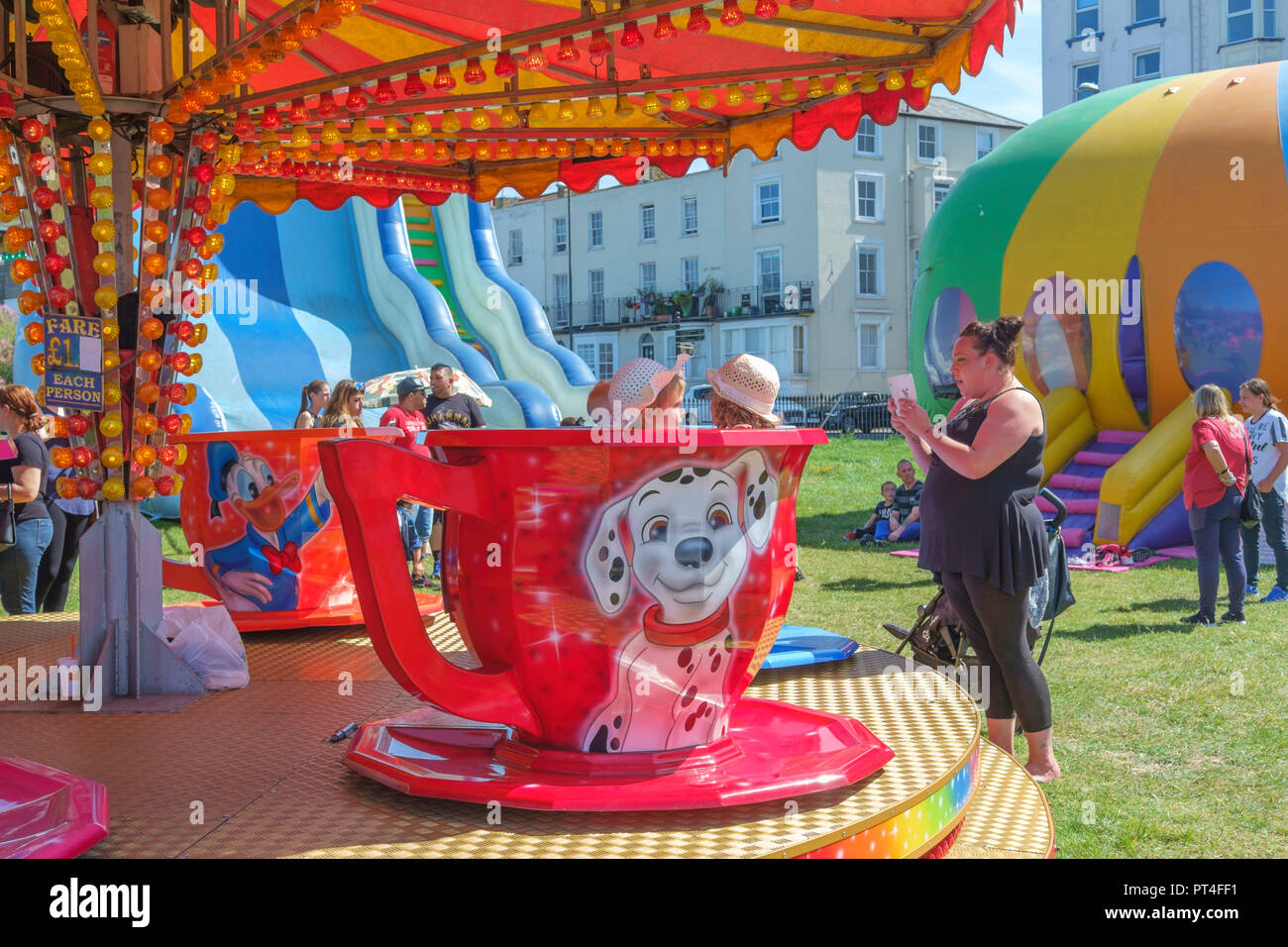 People enjoying the mobile funfair rides on the seafront at Margate, Kent, England, UK. Stock Photo