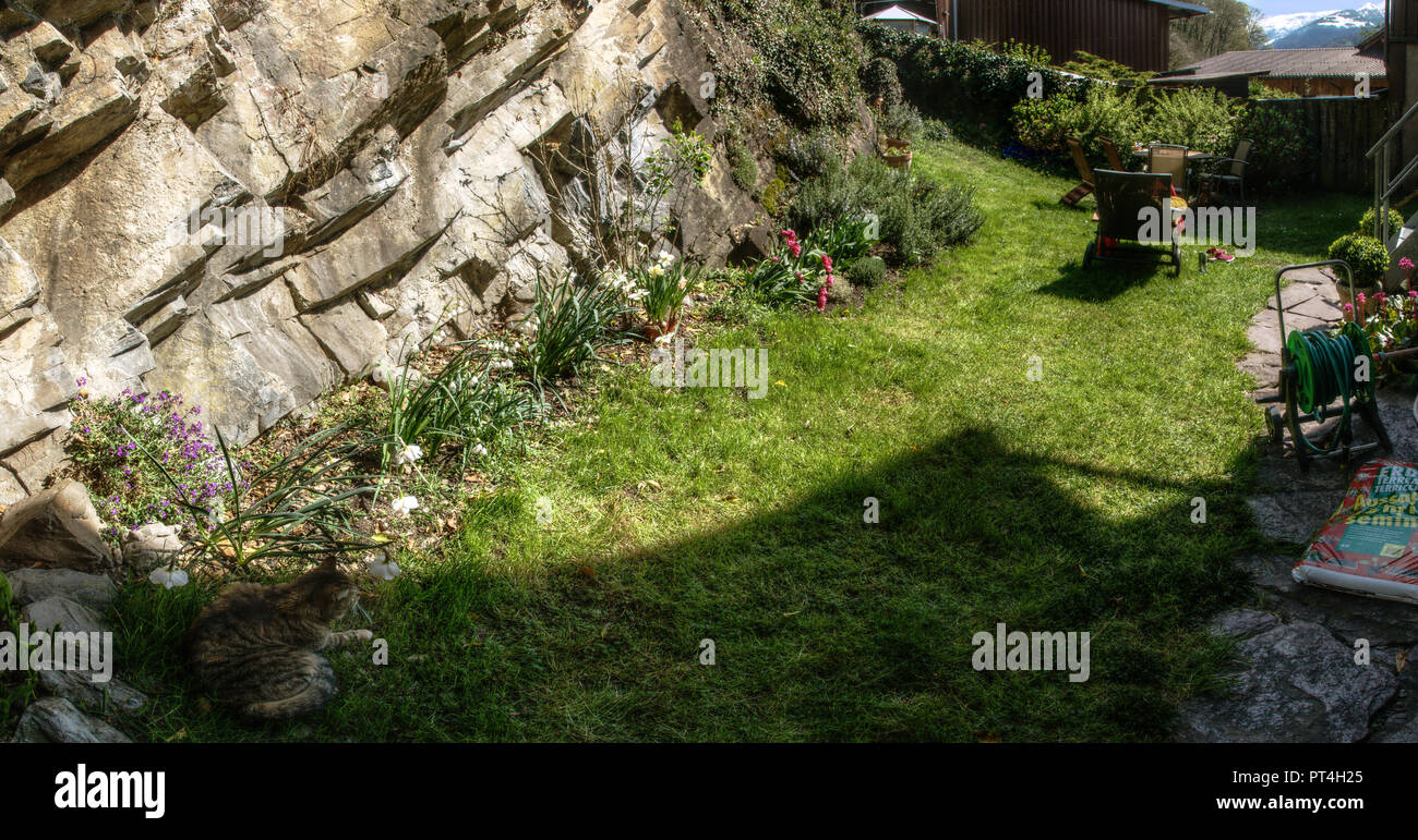 Section Of Informal Border Against Rock Face In Swiss Cottage