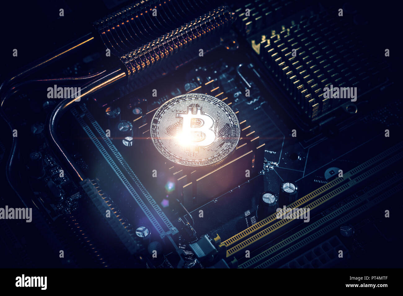 Golden Bitcoin Cryptocurrency on computer circuit board Stock Photo