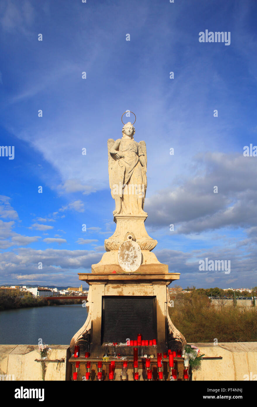 Historical statue of the Archangel Raphael, patron saint of Cordoba. It is located on the Roman Bridge which spans the Gaudalquivir River. UNESCO site Stock Photo
