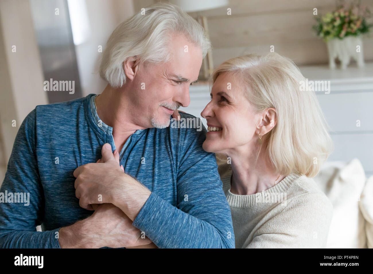 Caring senior man admiring aged woman enjoying sincere feelings Stock Photo