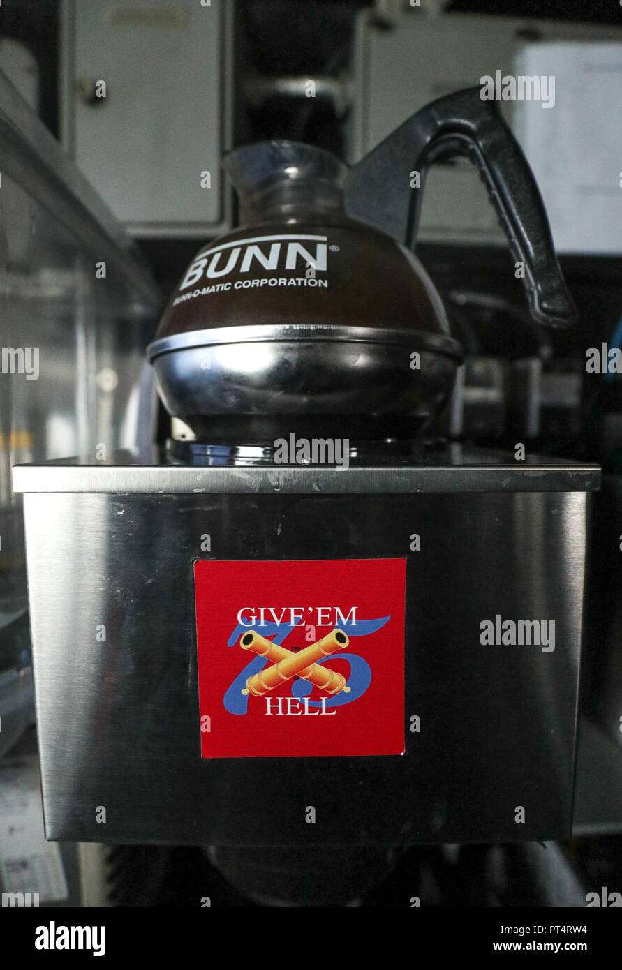 A Give 'Em Hell sticker on the side of a coffee machine on board the US Nimitz-class aircraft carrier USS Harry S. Truman, following its arrival into Stokes bay, Hampshire, during a visit to Portsmouth. Stock Photo