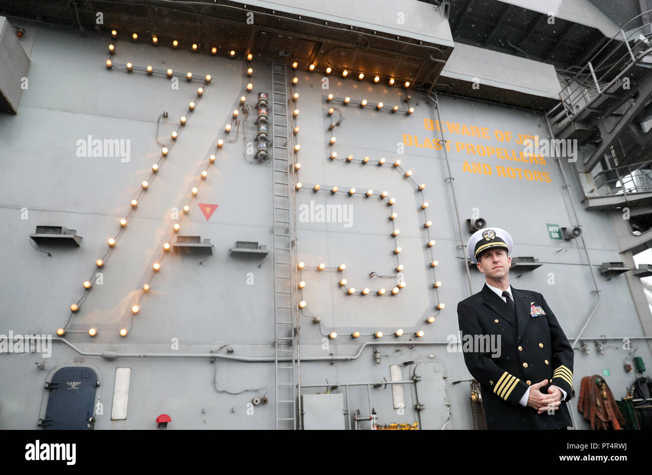 Captain Nicholas J. Dienna, Commanding Officer of the US Nimitz-class aircraft carrier USS Harry S. Truman, on the flight deck, following its arrival into Stokes bay, Hampshire, during a visit to Portsmouth. Stock Photo